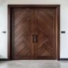 Dark brown wooden door with diagonal grooves on the surface with white wall in background_ Doors